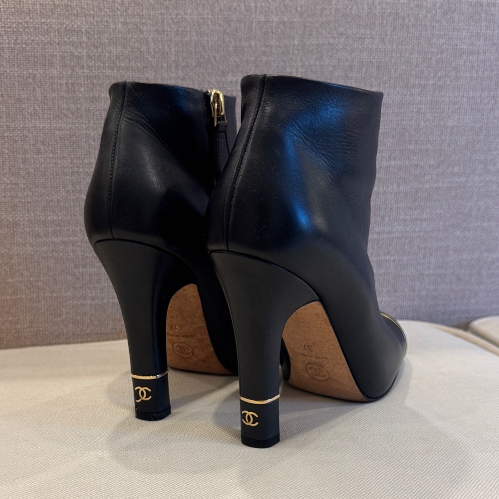 CHANEL Black Leather Heeled Boots with Gold Accents